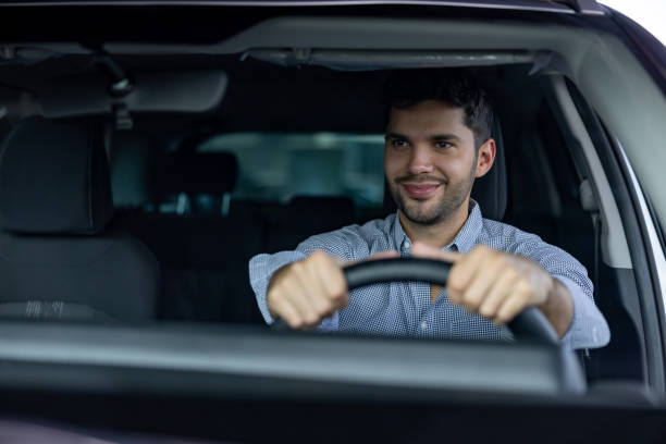 istock Man test driving a car at the dealership 1470035643