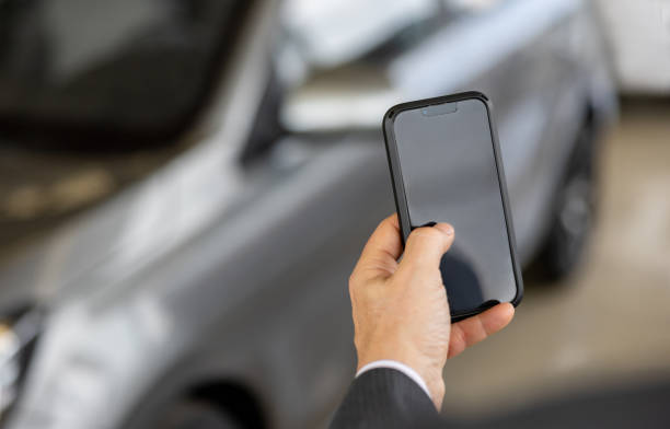 istock Car salesperson using his cell phone while working at a car dealership 1470035672