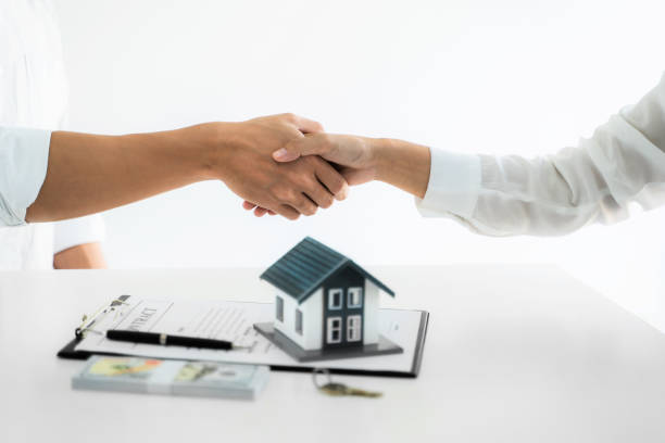 istock Real estate agent hand shaking with customer for house contract agreement. 1470035829