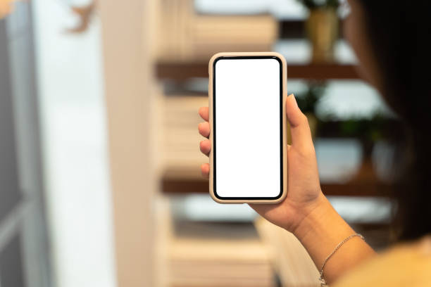 istock Woman hand's holding empty screen mobile phone at cafe. 1470035834
