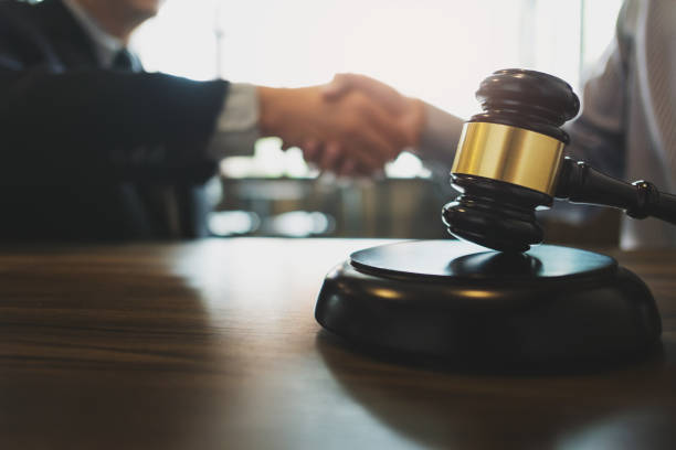 istock Counselor hand shaking with client successful legal contract. 1470035866