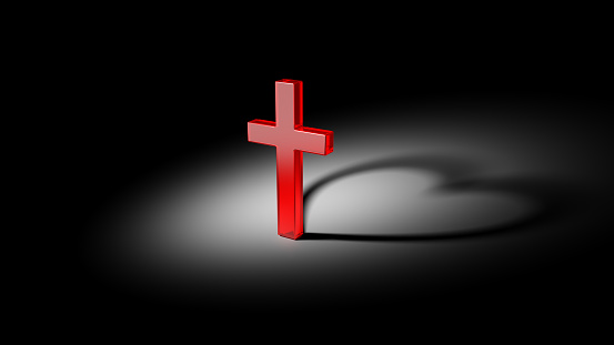 God is love. Red cross and shadow in heart form. Concept of faith and religion.