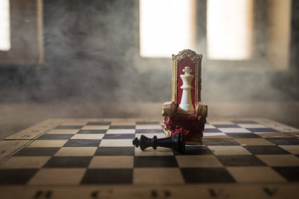 istock Red royal chair miniature on wooden table. Medieval Throne on chessboard. Chess board game concept of business ideas and competition and strategy ideas concept. Selective focus 1470037229