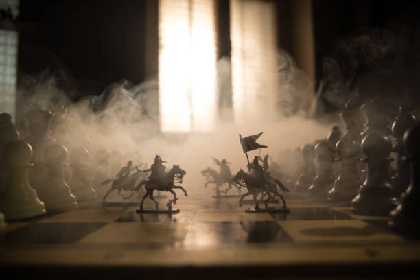 istock Medieval battle scene with cavalry and infantry on chessboard. Chess board game concept of business ideas and competition and strategy ideas Chess figures on a dark background with smoke and fog. 1470037254