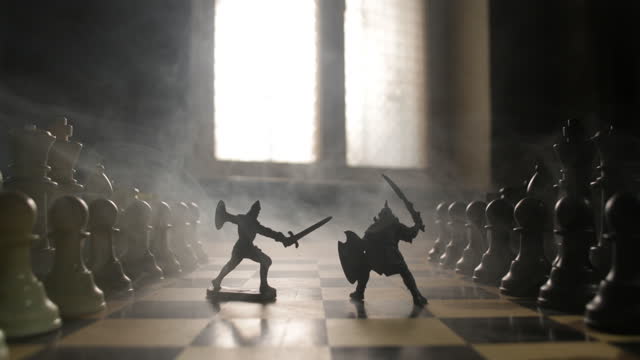 Medieval battle scene with cavalry and infantry on chessboard. Chess board game concept of business ideas and competition and strategy ideas Chess figures on a dark background with smoke and fog.
