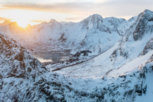 istock Snow covered mountain range on coastline in winter, Norway. Senja panoramic aerial view landscape nordic snow cold winter norway ocean cloudy sky snowy mountains. Troms county, Fjordgard 1470038443