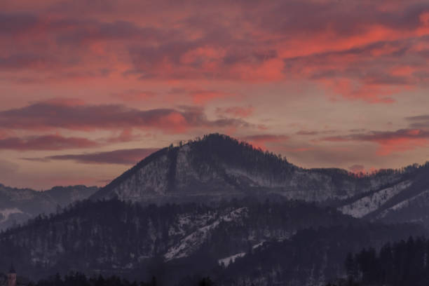 istock Winter morning with color clouds and big dark hills 1470038653