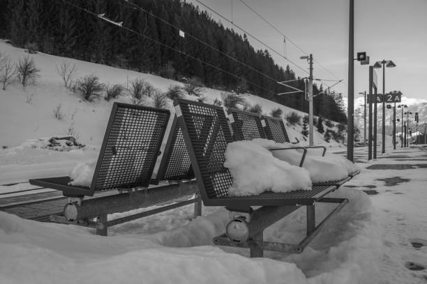 Winter evening in Spital am Pyhrn in Austria with snowy benches on platform Winter evening in Spital am Pyhrn in Austria with snowy and frosted benches on platform spital am pyhrn stock pictures, royalty-free photos & images