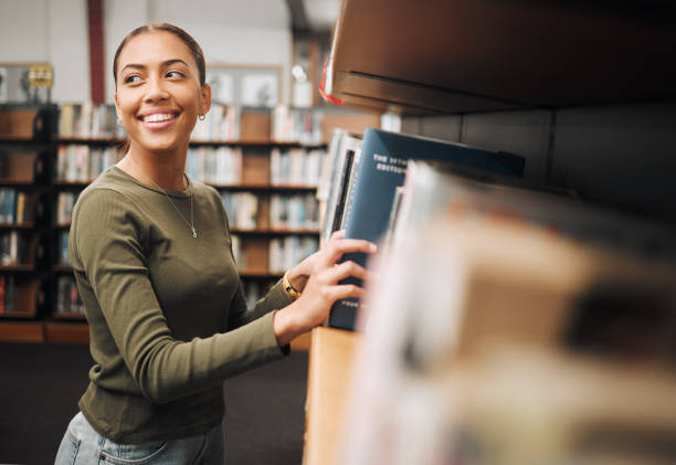 istock Student woman, search bookshelf and library for study, research and knowledge at university. College student, information and studying for education, college and learning for scholarship in Atlanta 1470038816