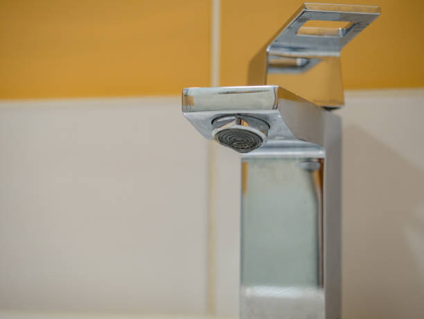 istock Running water from a square faucet in a modern bathroom 1470040298