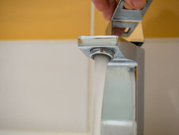 istock Running water from a square faucet in a modern bathroom 1470040306