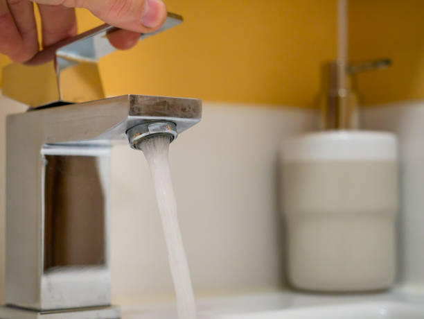istock Running water from a square faucet in a modern bathroom 1470040327