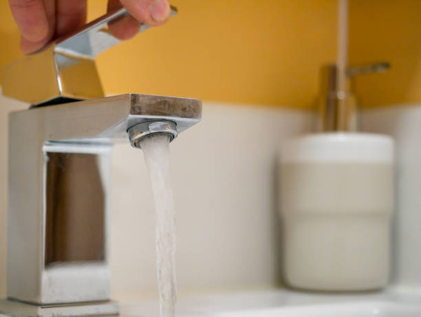 istock Running water from a square faucet in a modern bathroom 1470040328
