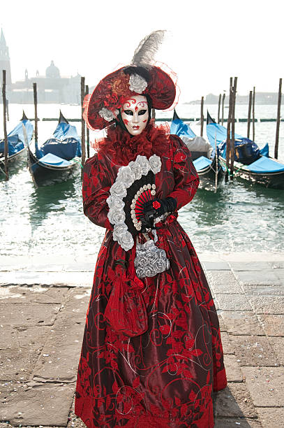 istock Venice mask in red costume on pier 147004495