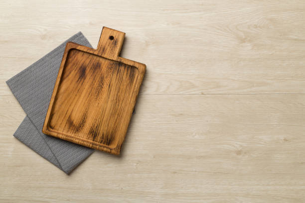istock Cutting board with towel on wooden background, top view 1470048173
