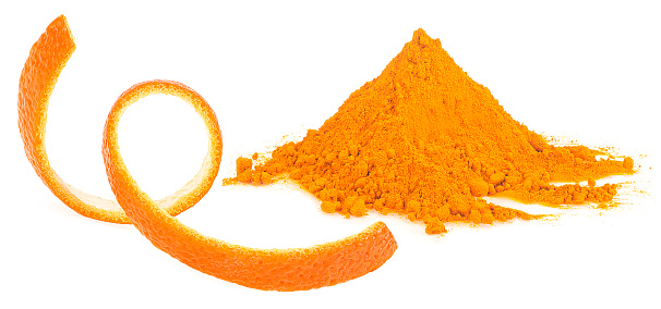 Orange powder with orange fruit peel isolated on a white background