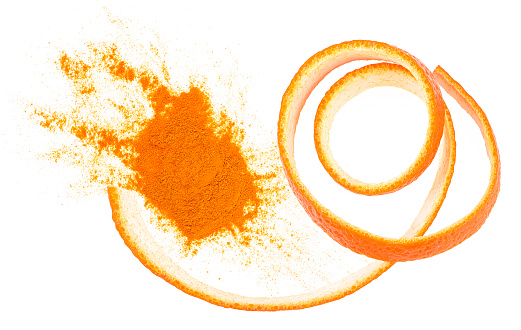 Dried orange powder with fresh orange zest isolated on a white background, top view.