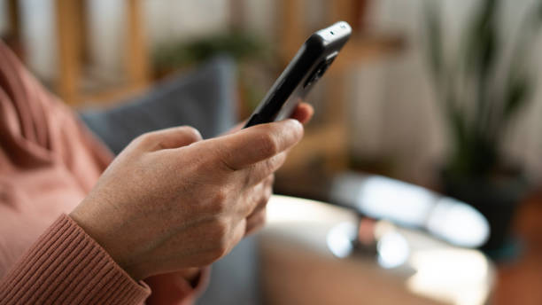 istock Close-up Woman hand using phone at home 1470048307