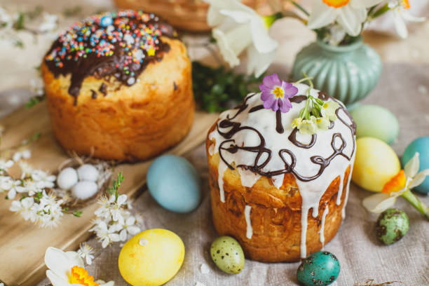 istock Homemade easter bread and natural dyed easter eggs with spring flowers on linen napkin on rustic table. Traditional Easter food. Happy Easter! 1470048396