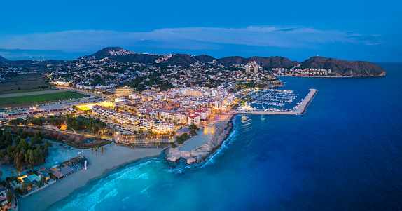 Moraira beach at sunset in Teulada Drone aerial skyline in blue Mediterranean sea of Alicante Spain in Marina Alta of Costa Blanca