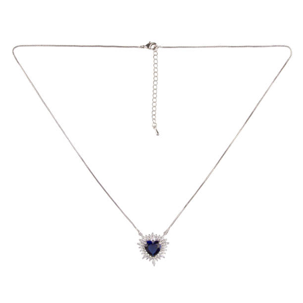 istock Silver pendant with a blue diamond sapphire on a thin chain on a white background 1470054298