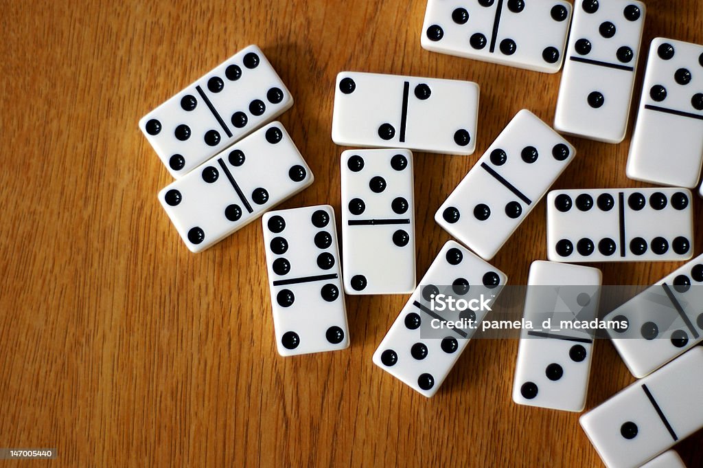 Table of Dominos A game of dominoes are easy.  Just match the numbers and try to end with multiples of 5's. Domino Stock Photo