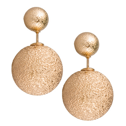 Fashionable gold earrings on a white isolated background