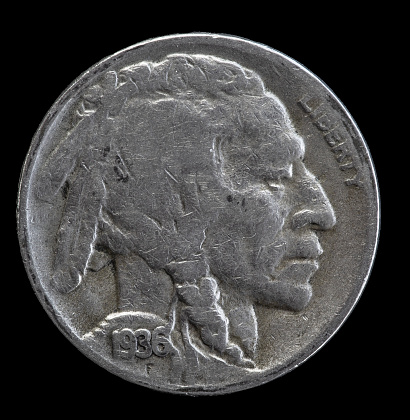 Native American man in profile with braids and feather on a 1936 buffalo nickel.
