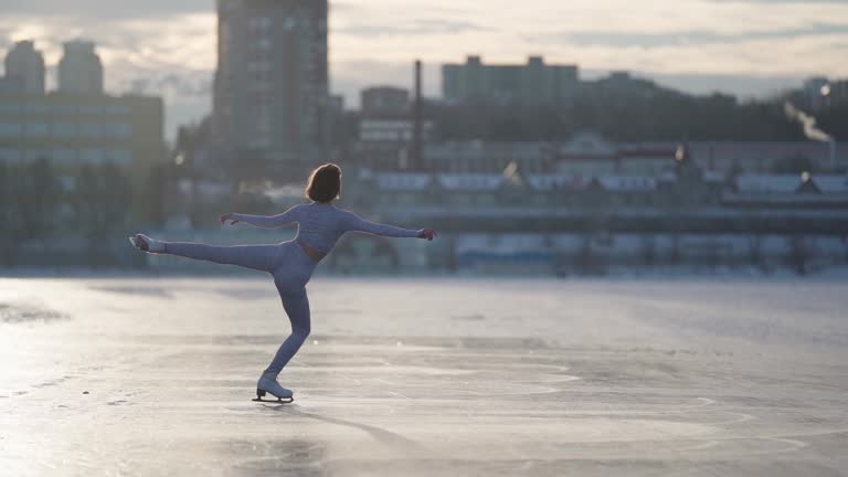 Young Figure Skating Woman On The  Frozen River In Winter. Full Body Shot A.