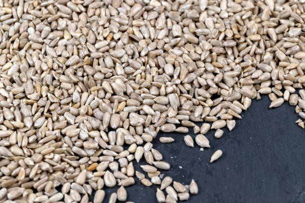istock Sunflower seeds peeled from the black shell 1470061331