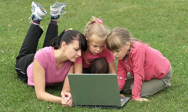 istock Mom and daughters at laptop 147006370