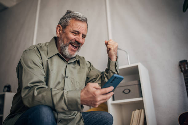 istock Elderly man uses smartphone, sees positive news 1470066083