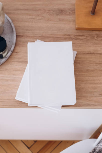 istock Blank book or magazine presentation in interior. White book mockup. White magazine mockup on the table. Album with clean pages. White book cover mockup in scandinavian style 1470068068
