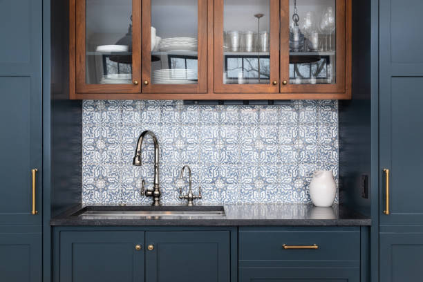 istock A kitchen sink detail with blue cabinets and tiled backsplash. 1470068172