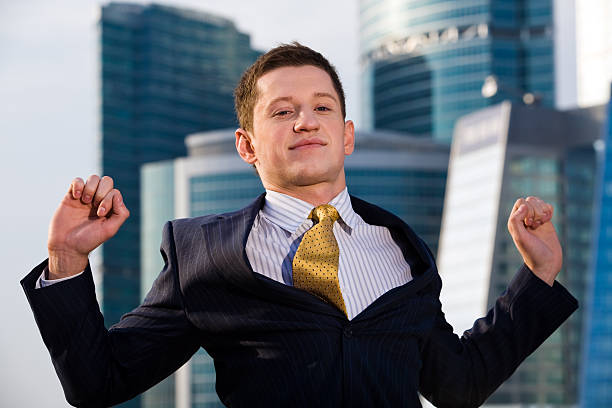 Businessman standing with outstretched arms stock photo