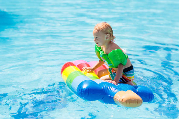 istock Kids on inflatable float in swimming pool. 1470071679