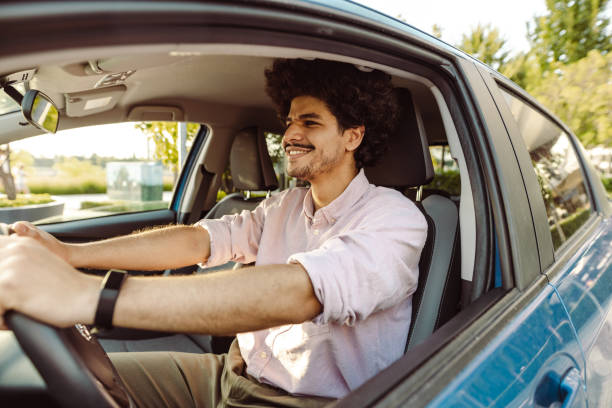 istock Young man driving a car with pleasure 1470073655