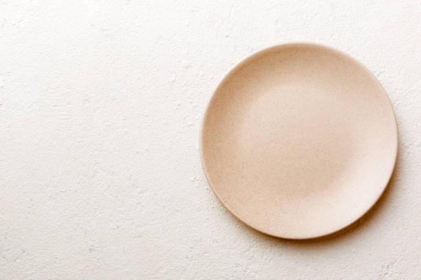 istock Top view of empty light plate on cement background. Empty space for your design 1470075108