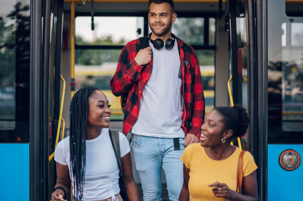 istock Multiracial friends going out of the bus 1470075221
