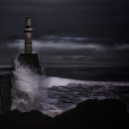 A stormy North Sea At night taken from the south breakwater pier in Aberdeen, Scotland.