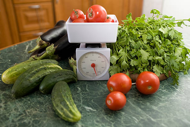 kitchen scale and vegetables stock photo