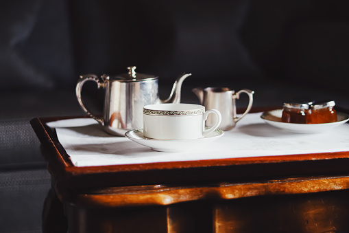English tea served on antique coffee table.