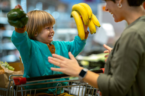istock A mother with a child in a store with fresh vegetables 1470081203