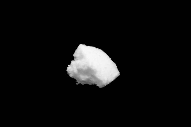 istock White snow isolated on black background close up 1470081243