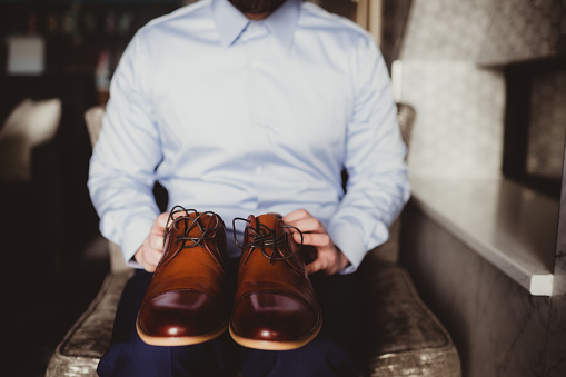 Man in button up shirt, dress pants and dress shoes