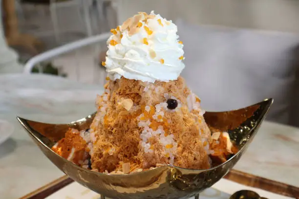 Photo of Royal Thai milk tea snowflake with soft bread and topped with whipped cream.