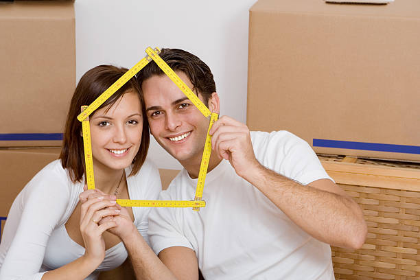 istock Happy couple in new home with ruler frame around face 147008356
