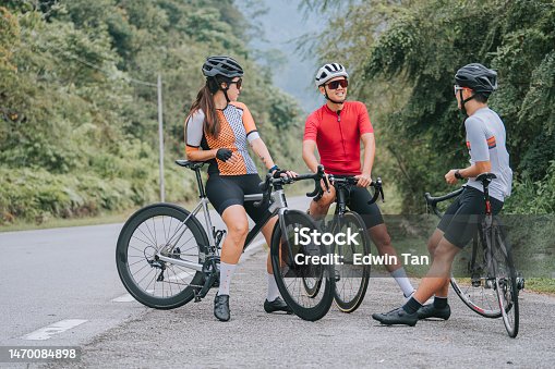 istock Asian Chinese Cyclist resting at roadside waiting for team mates 1470084898