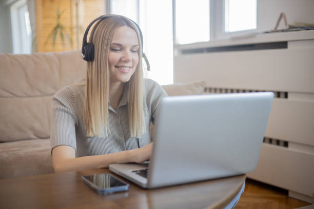 istock Happy young woman is learning online 1470084901