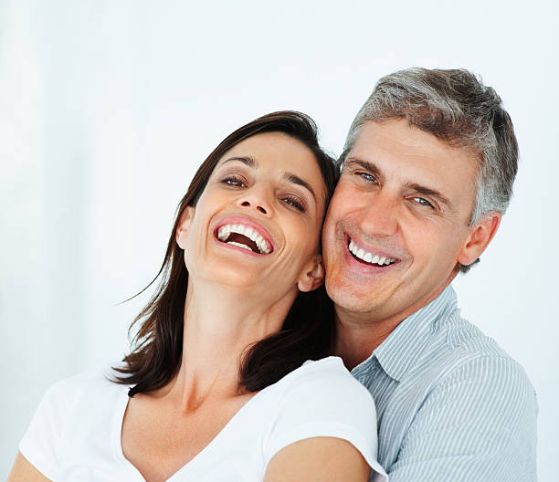 Close-up of a mature couple laughing Close-up of a mature couple laughing teeth bonding stock pictures, royalty-free photos & images